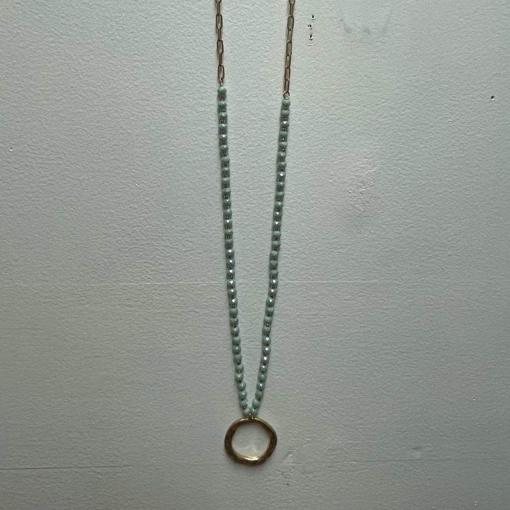 Wish necklace featuring a large gold round pendant